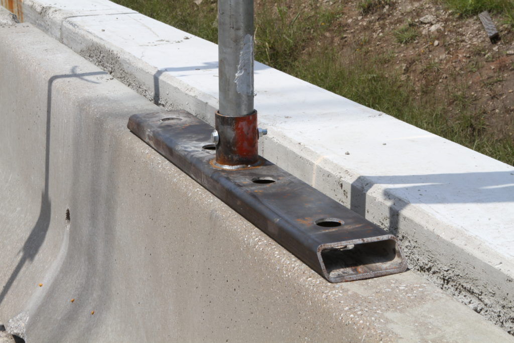 Sign on Concrete Median Barrier - Roadside Safety Pooled Fund